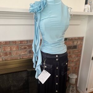 Sky light blue top; slinky and high neck with bow. I love it and too small